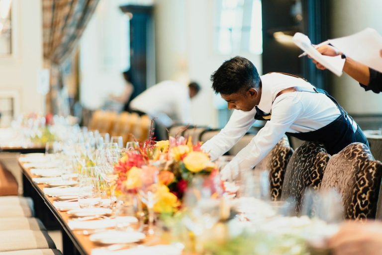 Staff setting a banquet table