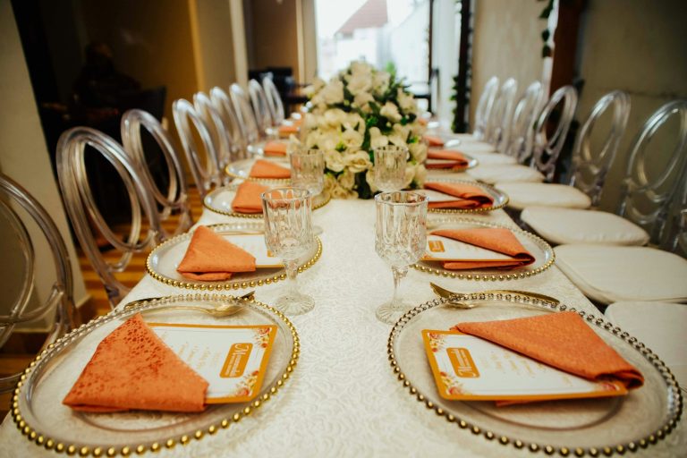 Banquet table setting with orange napkins
