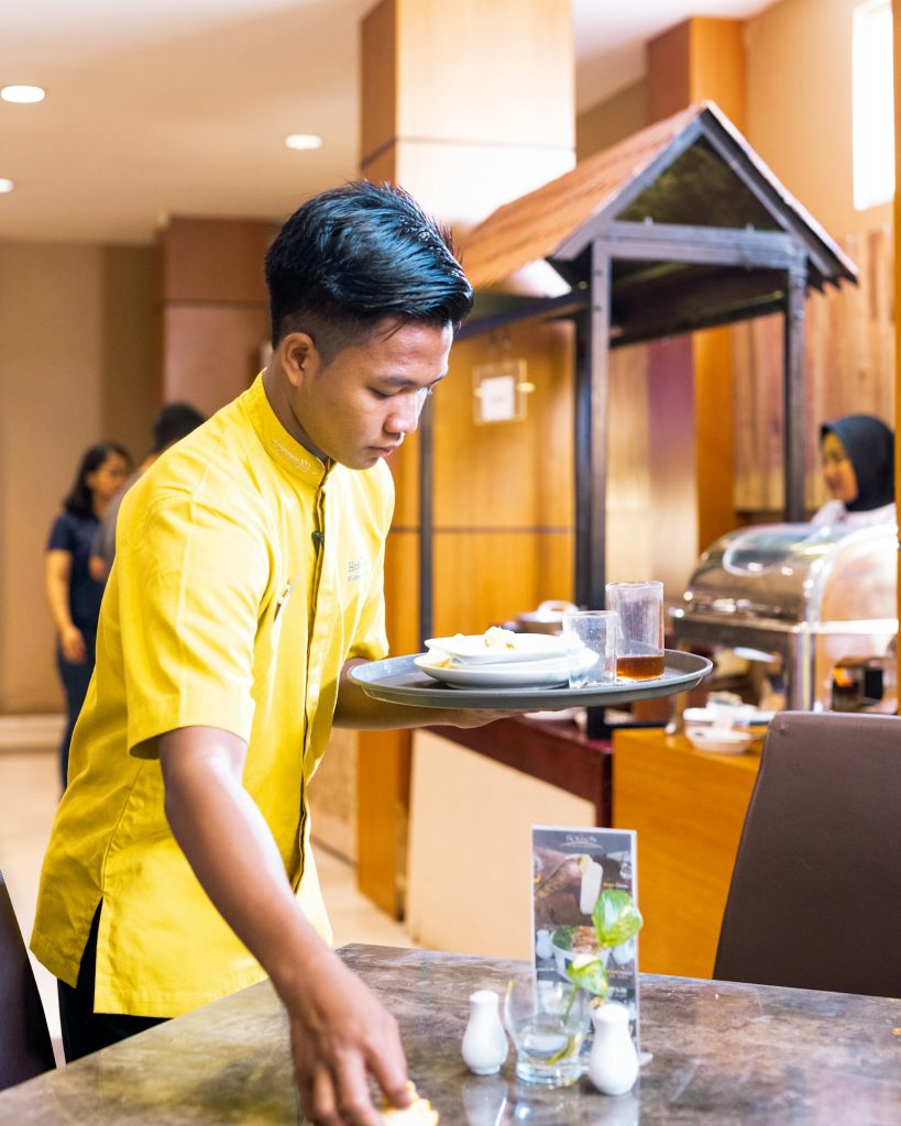 Server carrying plates at an event